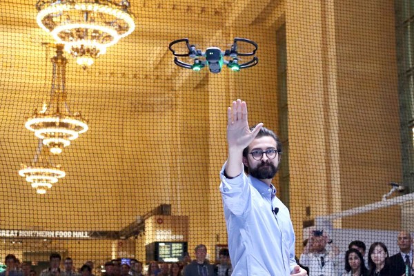 Michael Perry, director of strategic partnerships of DJI, demonstrates the palm-sized drone Spark during an event in New York. PROVIDED TO CHINA DAILY