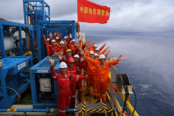 Workers celebrate successful trial extraction of natural gas hydrate in South China Sea last month. (Photo provided to China Daily)