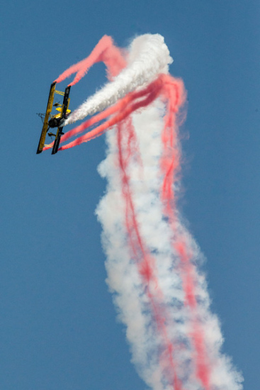 A biplane from AVIClub, a major general aviation club in China, spews contrails at a show in Anyang, Henan province, last month. (Photo/Xinhua)