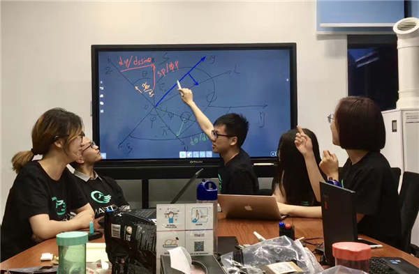 Li Qiucheng (center) from Tsinghua University speaks with classmates in an innovation course. Provided To China Daily