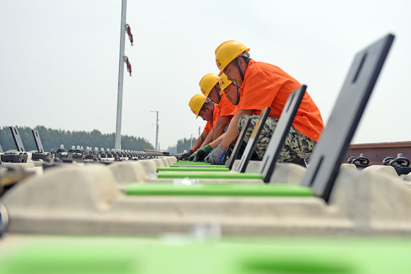 Technicians work at the Liaoning section of a high-speed railway in Northeast China's Liaoning province, June 17, 2017. (Photo/Xinhua)
