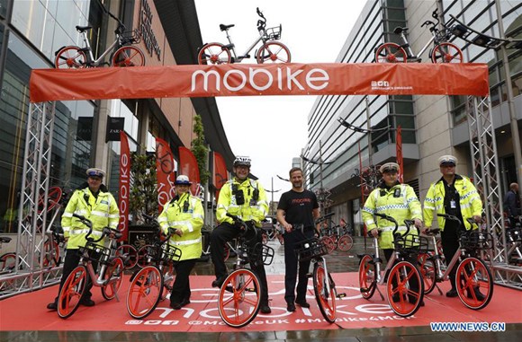 Manchester Metropolitan Police pose for a group photo during the launch of Mobike in Manchester, Britain on June 29, 2017. Mobike, one of China's largest bike-sharing companies, launched its service in the Greater Manchester, Britain, on Thursday. (Xinhua/Craig Brough)