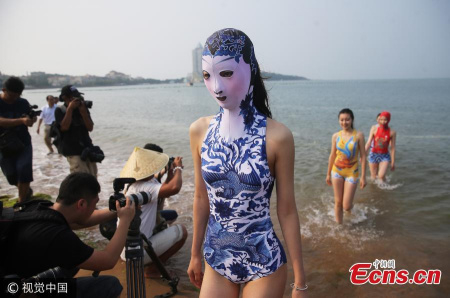 Models show a new version of the face-kini in Qingdao City, East China’s Shandong Province, June 28, 2017. The 7.0 version, according to its designer, features blue-and-white porcelain and embroidery, while in the past it has also featured Peking Opera and endangered animals. The face-kini mask is designed for swimmers and beachgoers to cover the head and reveals only the eyes, nose, and mouth of wearers to protect them from suntan, jellyfish and other irritants. It started in Qingdao and became popular among beachgoers in other coastal areas. (Photo/VCG)