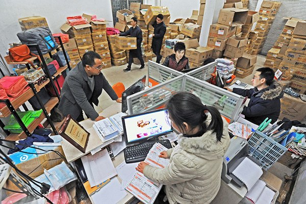 Employees of an online store process orders in Qingyanliu village, East China's Zhejiang province on Dec 29, 2015. (Photo/Xinhua)