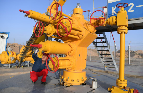 A worker checks oil transport facilities at the Tarim Basin in Xinjiang Uygur autonomous region. (Photo/Xinhua)