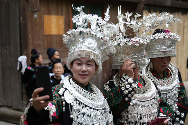 Locals pose for a photo before welcoming participants at the Conference for the Revival of Chinese Villages in Taijiang county, Southwest China's Guizhou province, on June 16. (Photo by Hou Liqiang/chinadaily.com.cn)