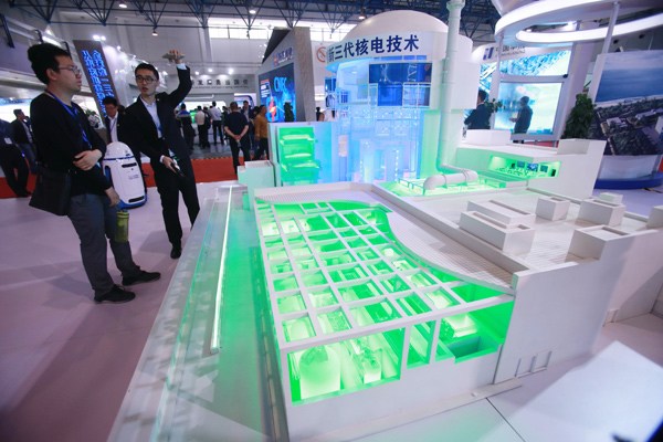 A visitor learns about China's third-generation nuclear technology at an exhibition in Beijing on April 29. (CHEN XIAOGEN / FOR CHINA DAILY)