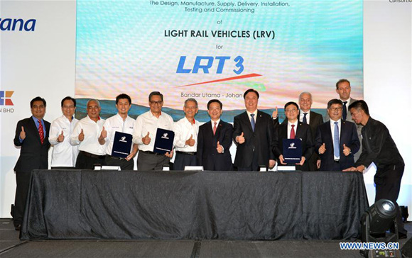 Guests pose for photos after the agreement signing ceremony held in Kuala Lumpur, Malaysia, on Aug. 2, 2017. Prasarana Malaysia, a public transport infrastructure company, signed an agreement with a consortium led by China's rolling stock manufacturer CRRC on Wednesday to introduce autopilot trains to Malaysia's public transportation system. (Xinhua/Chong Voon Chung)