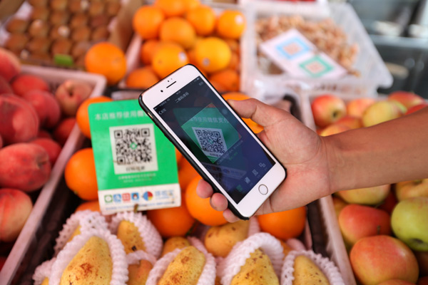 Alipay and WeChat Pay lead China's move to a cashless society, so customers can scan for purchases. (FENG YONGBIN / CHINA DAILY)