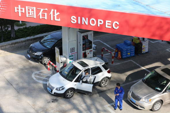 Cars refuel at a Sinopec gas station in Qingdao, Shandong province.