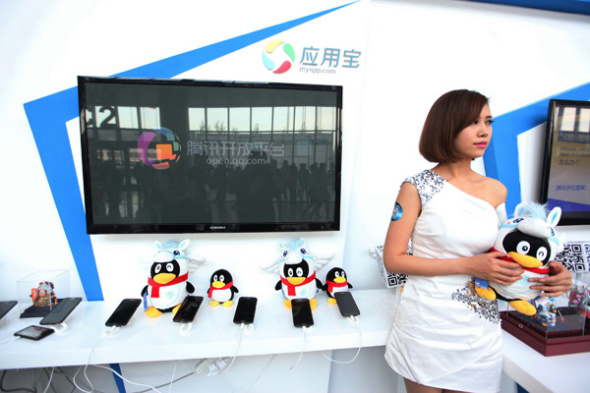 Tencent's stall at the 2014 Global Mobile Internet Conference in Beijing displays QQ's mascots. Teenagers in China are moving away from text-based online content and TV to video and social media such as QQ, the Chinese-language instant messenger.