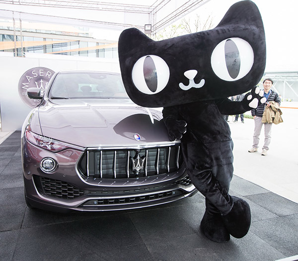 A Tmall mascot poses with a Maserati SUV Levante 350HP in Hangzhou, Zhejiang province, after the luxury carmaker sold its first 100 models on the Alibaba online platform. Starting at 999,800 yuan, Maserati sold all 100 cars in 15 minutes last year. (Xu Kangping/for China Daily)