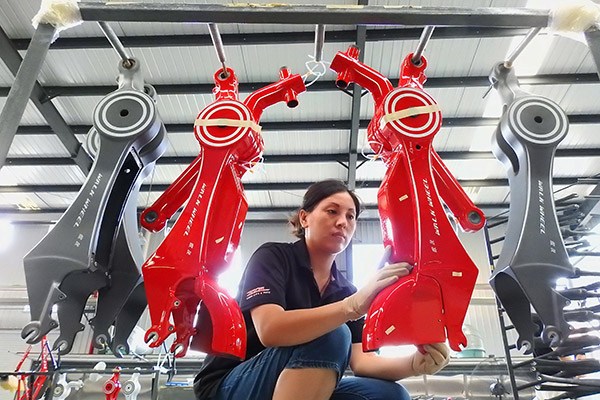 A technician tests a bicycle frame at a bike-manufacturing company in Lianyungang, Jiangsu province. (Geng Yue/for China Daily)