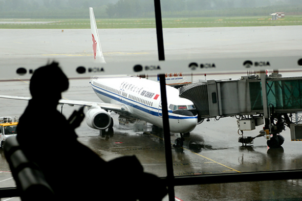 A passenger waits for his flight at Beijing Capital International Airport. (Photo/Xinhua)