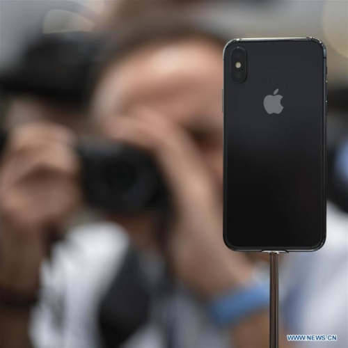 A man takes photos of new iPhone X displayed during a special event in Cupertino, California, the United States on Sept. 12, 2017. Apple Inc. released a series of new products and services in Cupertino on Tuesday. (Photo/Xinhua)