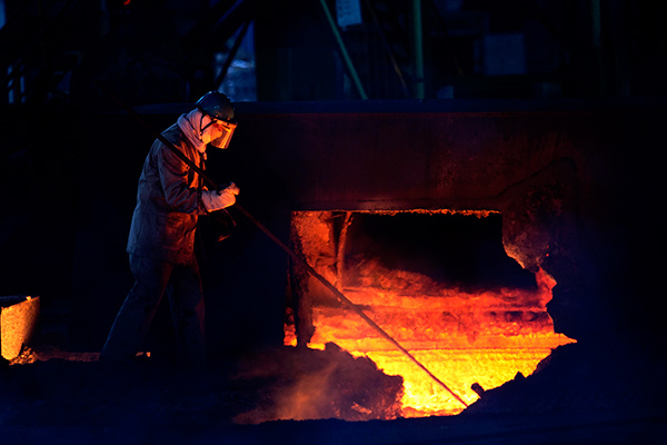 A worker takes samples of molten iron from a furnace of the China Baowu Steel Group in Wuhan, capital of Hubei province. (Photo provided to China Daily)