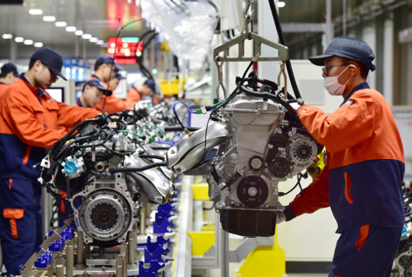 Technical workers assemble engines at a plant in Yiwu, Zhejiang province.(Photo provided for China Daily)