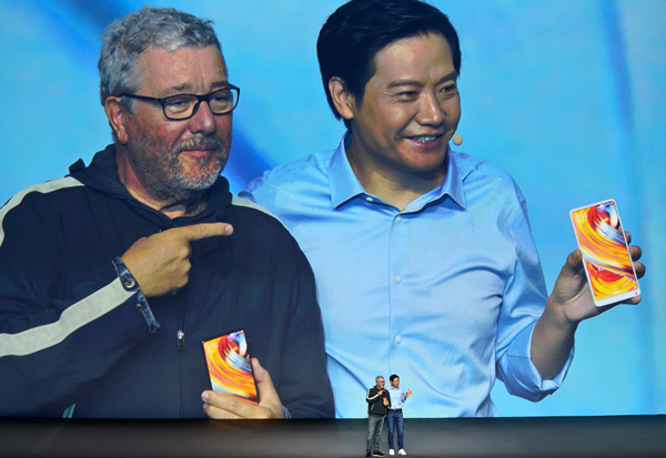 Lei Jun (right), chief executive officer of tech company Xiaomi, presents a full-screen smartphone with its French designer, Philippe Starck, at a new product launch event in Beijing on Sept 11. (Photo by Feng Yongbin/China Daily)