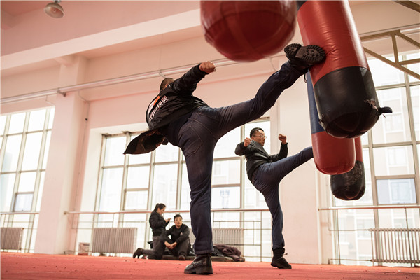 New team members work out at a training facility. (Photo by Zhou Gangfeng/For China Daily)