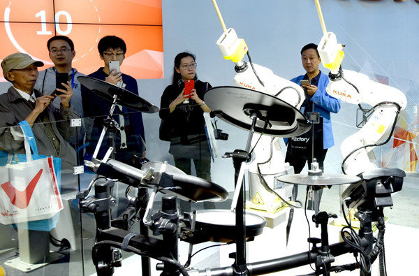 Robots made by German manufacturer Kuka AG play percussion at an exhibition in Shanghai. (Photo by Long Wei/For China Daily)