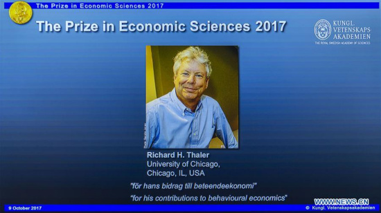 Photo of Richard H. Thaler is displayed on the screen during the press conference to announce the winner of the 2017 Nobel Prize in Economics in Stockholm, Sweden, on Oct. 9, 2017. (Xinhua/Shi Tiansheng)