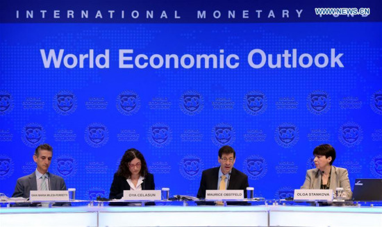 Maurice Obstfeld (2nd R), chief economist at the International Monetary Fund (IMF), attends a press briefing at the IMF headquarters in Washington D.C., the United States, on Oct. 10, 2017. The IMF on Tuesday raised its global growth forecast for 2017 and 2018 due to a broad-based recovery in Europe, China, Japan and the United States. (Xinhua/Yin Bogu)