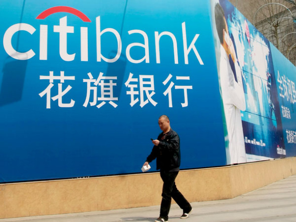 A pedestrian walks past a Citi billboard in Nanjing. The multinational financial service provider with a wide global network and local expertise is stepping up efforts to help Chinese companies reduce expansion risks in the economies related to the Belt and Road Initiative. (Photo provided to China Daily)