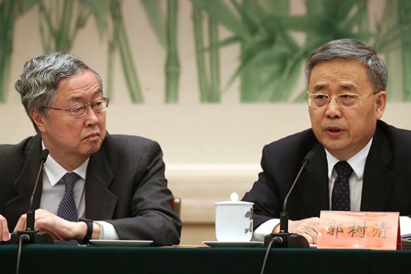 Central bank governor Zhou Xiaochuan (left) and Guo Shuqing, chairman of the China Banking Regulatory Commission, at the 19th National Congress of the Communist Party of China, Oct 19, 2017. (Photo/China Daily By Edmond Tang)