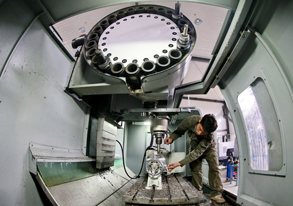 An employee works in a facility for the manufacturer of lasers in Tangshan, Hebei province. (Photo/Xinhua)