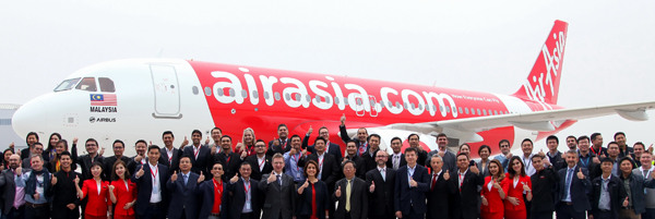 Officials from Airbus and Air Asia celebrate after the delivery ceremony for the A320neo aircraft in Tianjin on Wednesday.(Photo provided to China Daily)