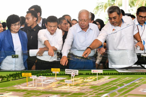 Malaysian Prime Minister Najib Razak (2nd R, Front), Alibaba founder and Executive Chairman Jack Ma (2nd L, Front) view a model of Alibaba's logistics affiliate Cainiao in Sepang, Malaysia, on Nov. 3, 2017. Alibaba announced here on Friday to launch the Electronic World Trade Platform (eWTP) where people can buy global and sell global. (Xinhua/Chong Voon Chung)
