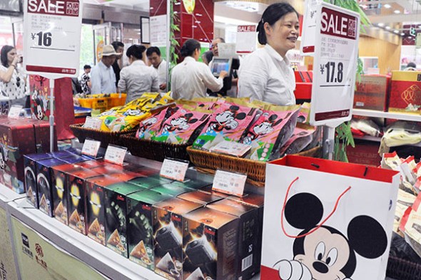 Mickey Mouse makes his mark in a Shanghai food store. The cartoon character was part of a licensing deal to promote snacks.YANG YI/CHINA DAILY