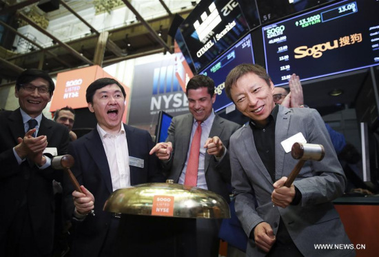 CEO of Sogou Inc. Wang Xiaochuan (2nd L, Front) and CEO of sohu.com Zhang Chaoyang (1st R, Front) attend the opening bell ceremony at the New York Stock Exchange in New York, the United States, on Nov. 9, 2017. (Xinhua/Wang Ying)