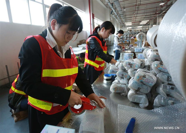 Staff members of a cross-border e-commerce company package products in Ningbo, east China's Zhejiang Province, Nov. 8, 2017. Cross-border e-commerce companies and courier services in Ningbo are busy preparing for the Singles' Day shopping spree which falls on Nov.11. (Xinhua/Huang Ruipeng)
