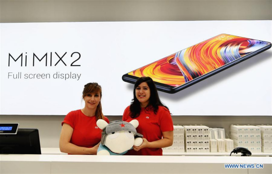 Staff members present a Xiaomi doll at a store in Madrid, capital of Spain, on Nov. 11, 2017. Xiaomi, one of the leading high-tech enterprises of China, opened on Saturday morning its two stores via its authorized re-sellers in Madrid. (Xinhua/Guo Qiuda)