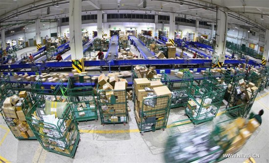 Employees work at a distribution center of Express Mail Service in Hengyang City, central China's Hunan province, Nov. 12, 2017. (Xinhua/Cao Zhengping)