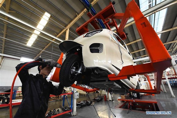 A staff worker works at the assembly line of an electric car manufacturer at Weifang City, east China's Shandong Province, Oct. 31, 2017.  (Xinhua/Wang Jilin)