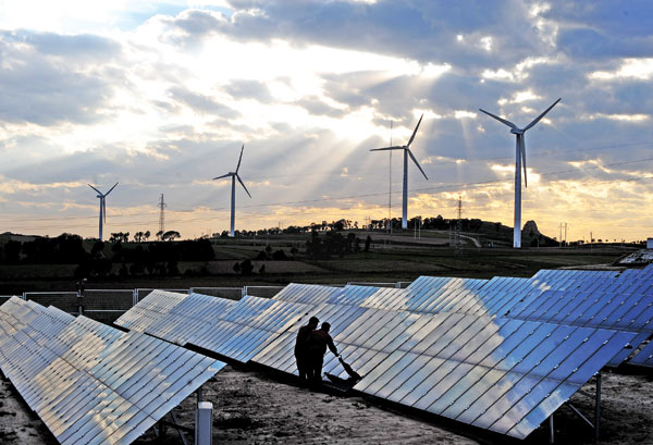 Workers check equipment at a wind farm in Shanxi province. (Photo/Xinhua)