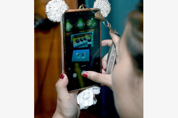 Mobile phone apps allow users to download their favorite music and sing karaoke.(Hao Fei/China Daily)