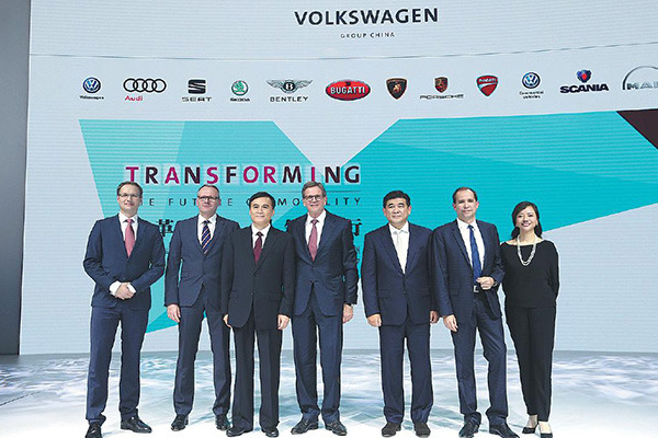 Executives from Volkswagen Group China and partner JAC Motors pose for a photo at the Guangzhou auto show. (Photo provided to China Daily)