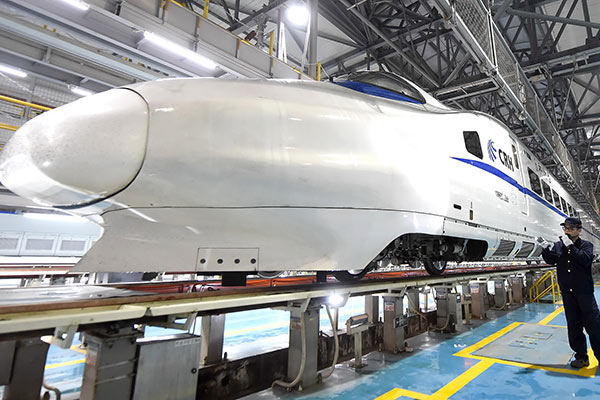A technician checks a CRH train in Chongqing.(Photo/Xinhua)