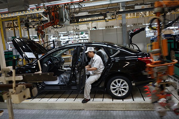 A worker on the production line of Dongfeng Motor Corp in Guangzhou, capital of Guangdong province. Provided to China Daily