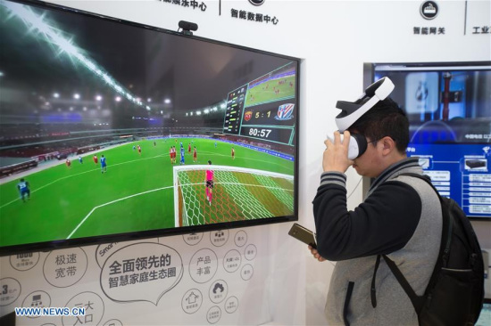 A man watches football match with VR glasses at the Light of Internet Exposition of the fourth World Internet Conference in Wuzhen of Tongxiang City of east China's Zhejiang Province, Dec. 2, 2017. (Xinhua/Meng Dingbo)