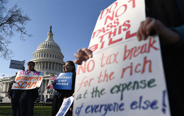 People protest against tax reform on Capitol hill in Washington DC, the United States, on Dec 1, 2017. The US Senate on Saturday morning narrowly passed the Republican bill to overhaul the tax code in decades, moving one step closer to the first major legislative victory of the Trump administration and congressional Republicans. (Photo/Xinhua)
