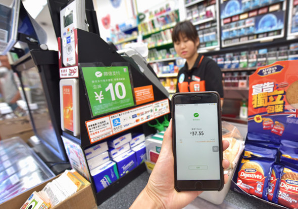 A customer pays his bill with WeChat Pay in Hong Kong. (Photo/Xinhua)