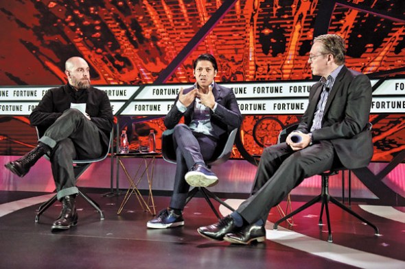 Charles Hayes (left), executive managing director of IDEO Asia, and Robbie Antonio (center), founder and CEO of Revolution Precrafted, talk at a panel during the conference, moderated by Clay Chandler, executive editor of Time International. (Photo/China Daily)