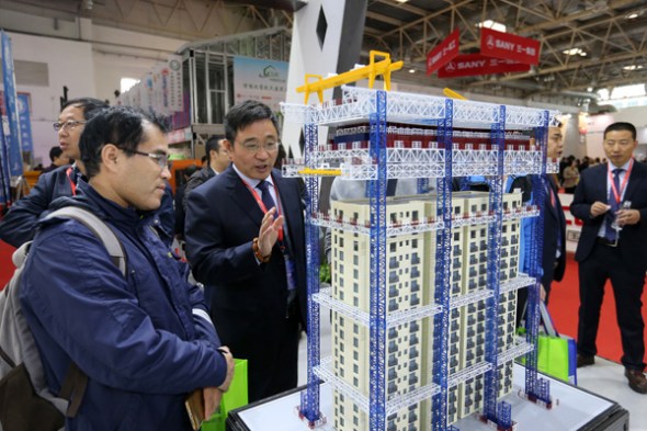 A visitor looks at a green building model at the 16th China International Exposition of Housing Industry, Products and Equipment held in Beijing in October. (Photo by Wang Zhuangfei/China Daily)