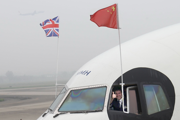 A British Airways captain poses for photographs on a panda-themed airplane at the Chengdu Shuangliu International Airport in Sichuan province. (Photo by Xie Minggang/For China Daily)