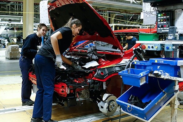 Workers assemble a car at AB Volvo's factory in Belgium.(Photo/Xinhua)