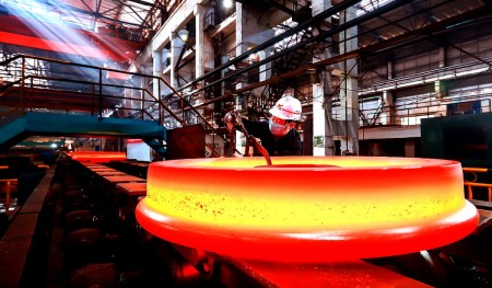 A worker tests new wheel products at a steel plant in Ma'anshan, Anhui Province. (Photo/CHINA DAILY)
